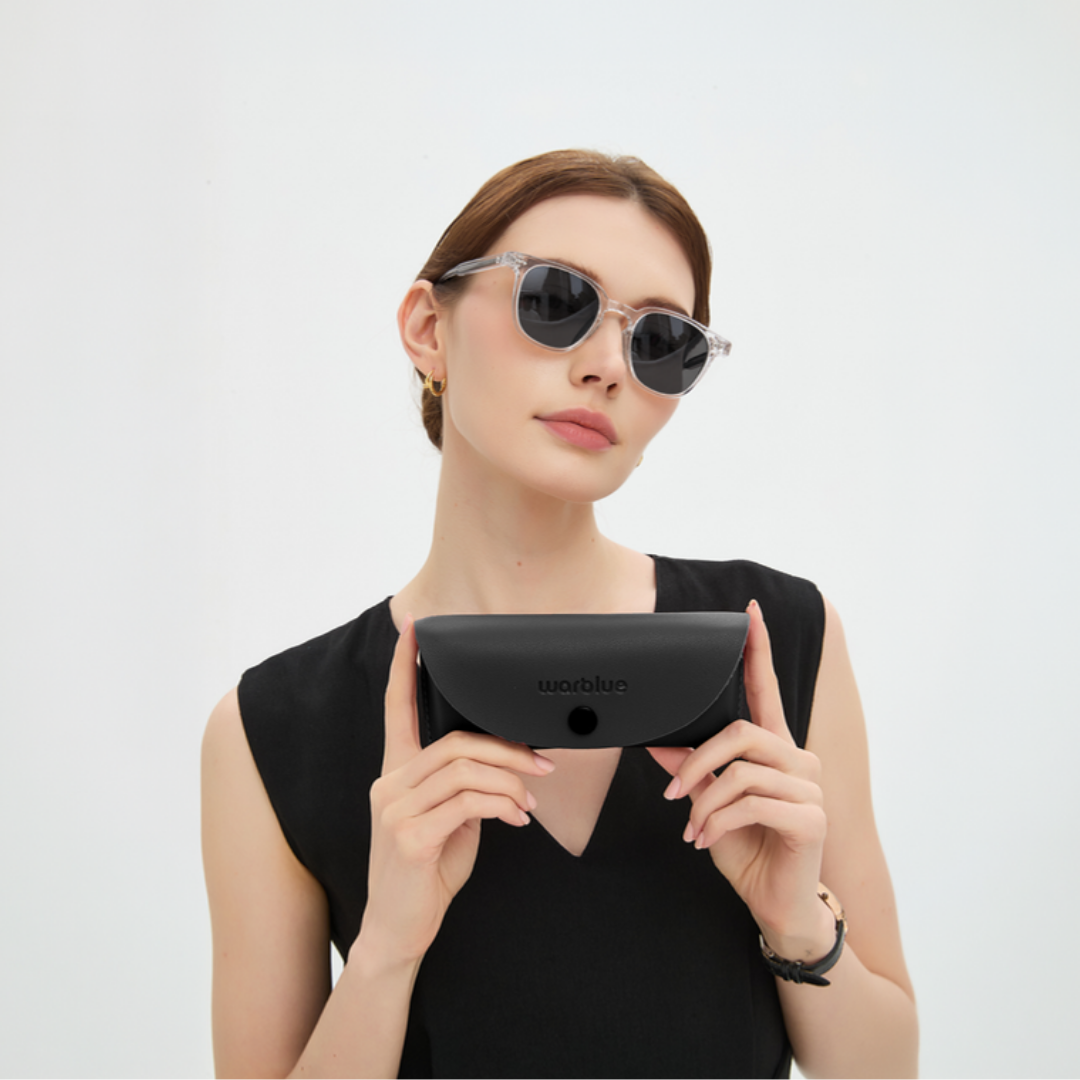 Modèle tenant l’étui de protection Auguste – lunettes de soleil à monture Crystal